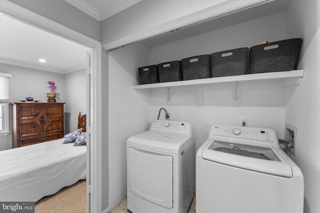 washroom with laundry area, washing machine and dryer, and ornamental molding