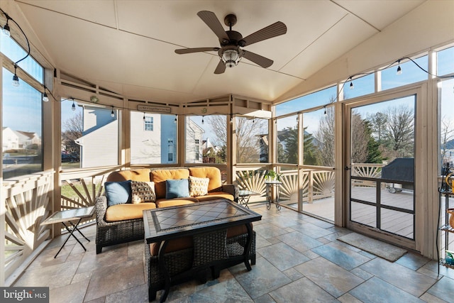 sunroom / solarium featuring a ceiling fan and lofted ceiling