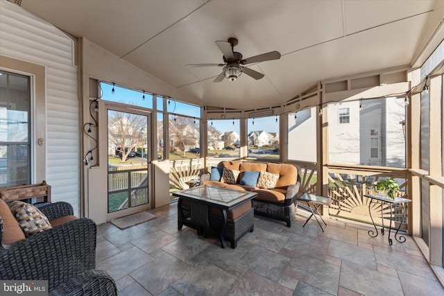 sunroom / solarium with ceiling fan and vaulted ceiling