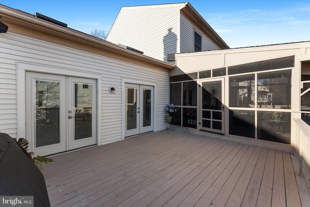 wooden deck featuring french doors and a sunroom