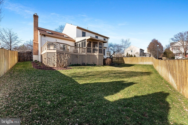 view of yard featuring a fenced backyard and a sunroom