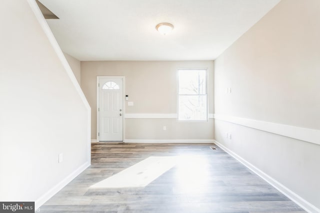 entryway featuring baseboards and wood finished floors