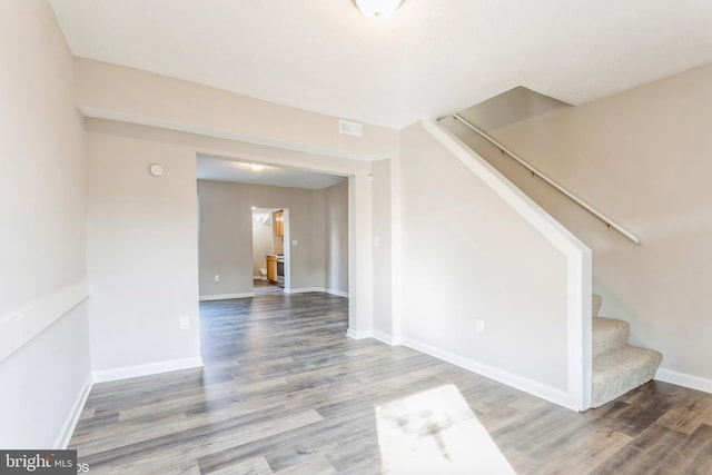 interior space featuring visible vents, stairs, baseboards, and wood finished floors