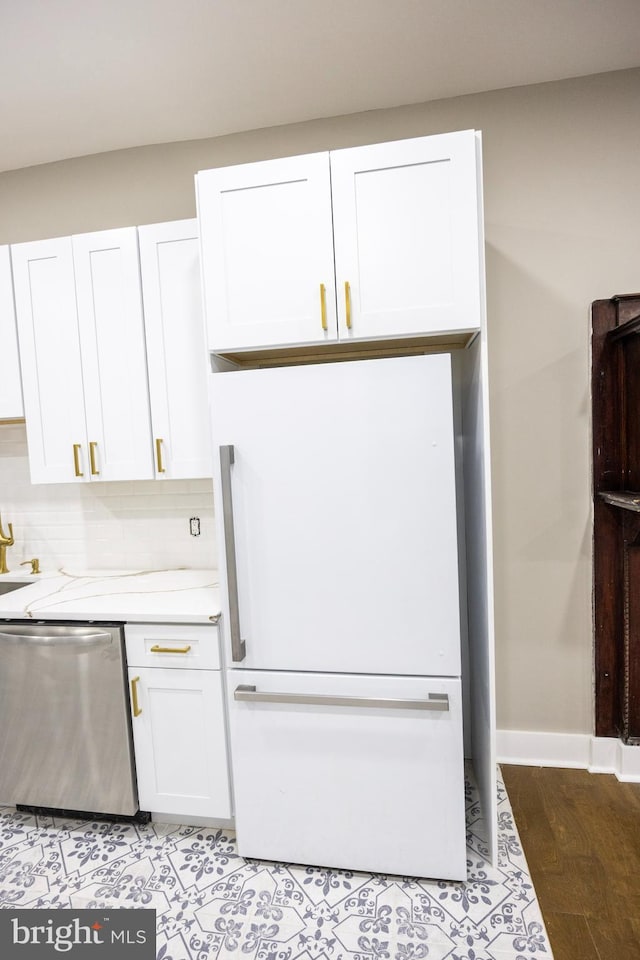 kitchen featuring white cabinetry, freestanding refrigerator, light countertops, dishwasher, and tasteful backsplash