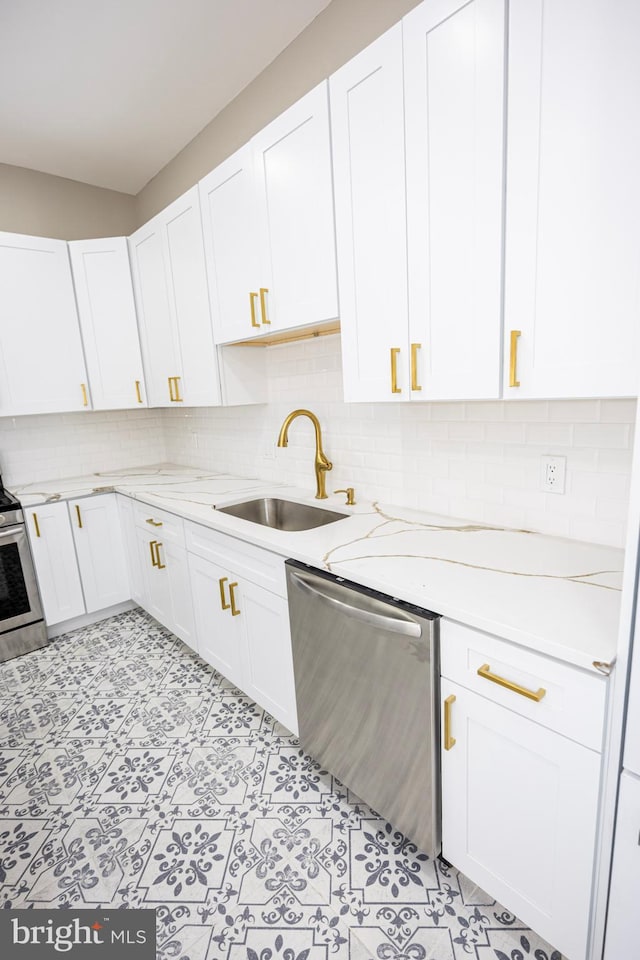 kitchen featuring white cabinetry, stainless steel appliances, and a sink