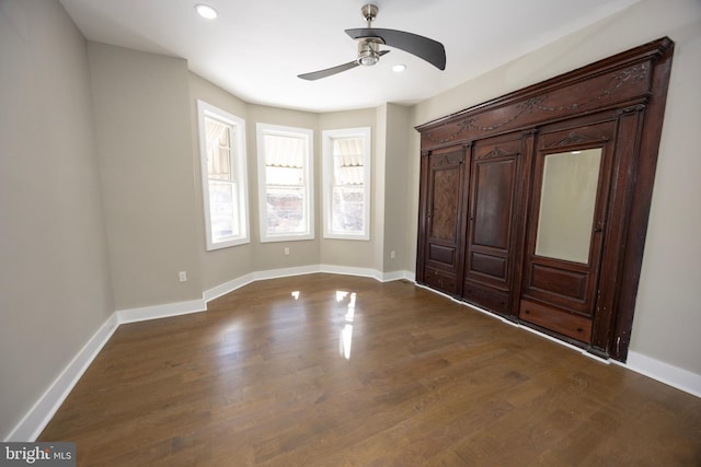 unfurnished bedroom with recessed lighting, baseboards, dark wood-style floors, and ceiling fan