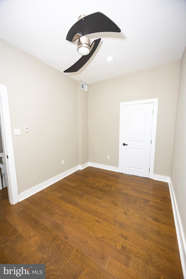 empty room featuring recessed lighting, wood finished floors, visible vents, and baseboards