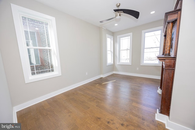 unfurnished living room with recessed lighting, a ceiling fan, baseboards, and dark wood-style flooring