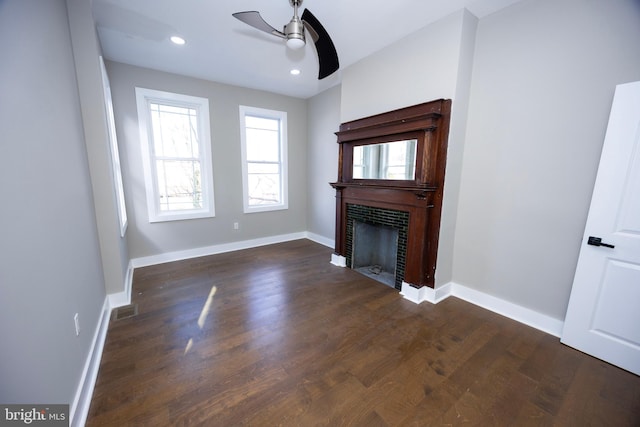 unfurnished living room with baseboards, recessed lighting, a tile fireplace, wood finished floors, and a ceiling fan