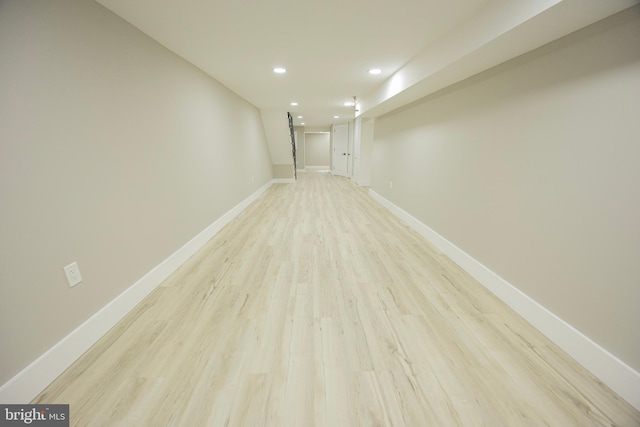 spare room with light wood-style flooring, recessed lighting, and baseboards