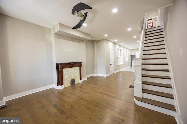 interior space featuring dark wood-type flooring, stairway, recessed lighting, and baseboards