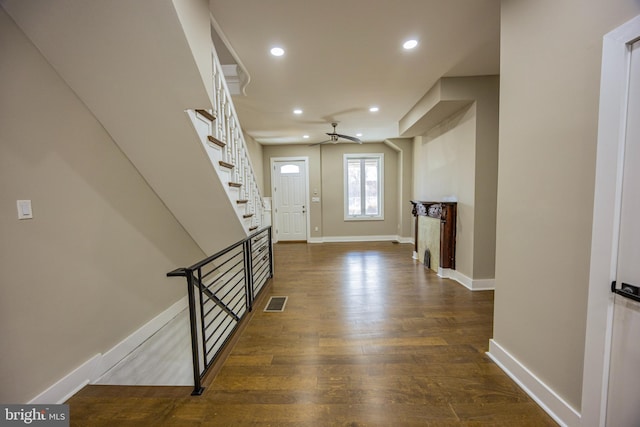 entrance foyer with visible vents, baseboards, dark wood finished floors, recessed lighting, and stairs