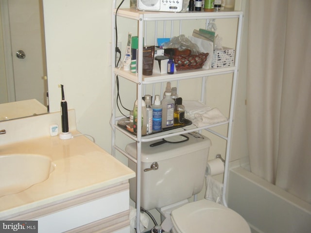 bathroom featuring a sink, toilet, and shower / tub combo