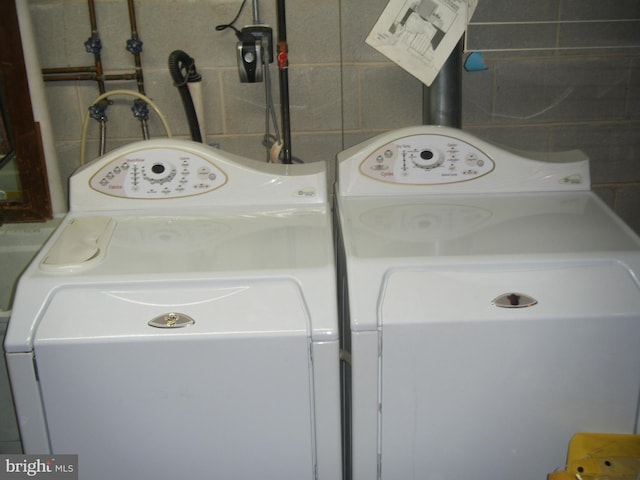 laundry room with washer and clothes dryer and laundry area