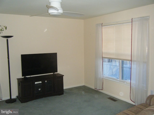 unfurnished living room with carpet, a ceiling fan, visible vents, and baseboards