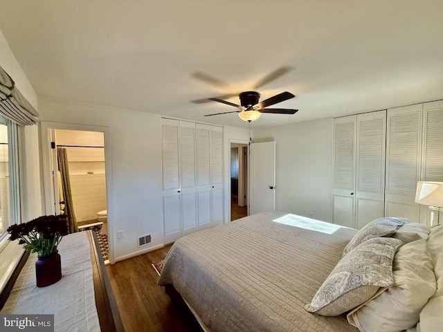 bedroom featuring visible vents, connected bathroom, baseboards, wood finished floors, and a ceiling fan