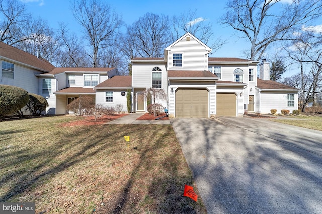 view of front of house featuring aphalt driveway, a front lawn, a chimney, and an attached garage