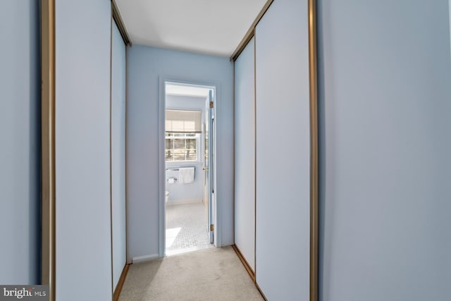 hallway with light colored carpet