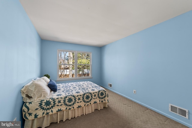 carpeted bedroom with baseboards and visible vents