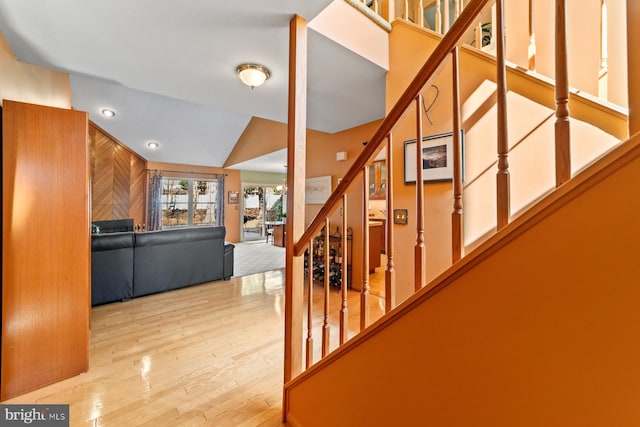 interior space featuring stairway, lofted ceiling, and wood finished floors