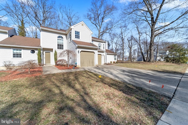 view of front of property featuring aphalt driveway, a front lawn, and a garage