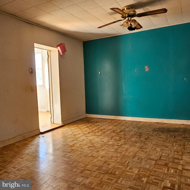 spare room featuring baseboards and ceiling fan