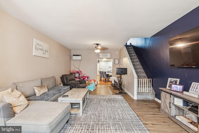 3144 Gaul St, Philadelphia, PA 19134 - living room with stairway, baseboards, ceiling fan, a wall mounted air conditioner, and wood finished floors