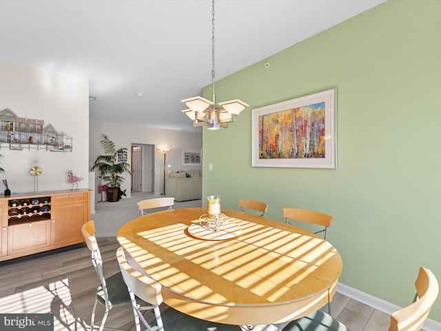 dining space featuring baseboards and light wood-style flooring