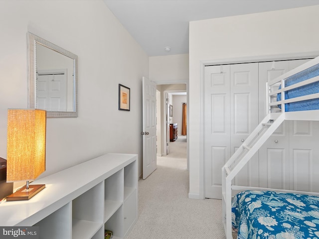 bedroom with a closet and light carpet