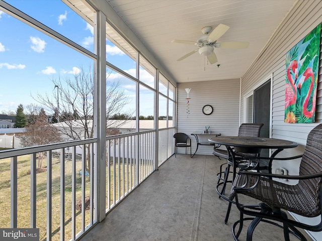 sunroom featuring a ceiling fan