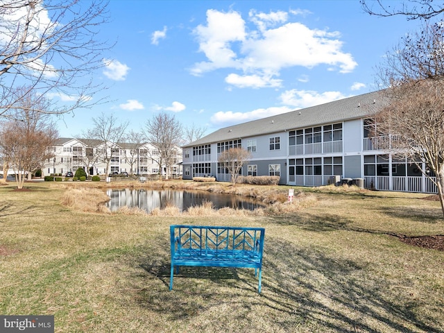 view of community with a yard and a water view