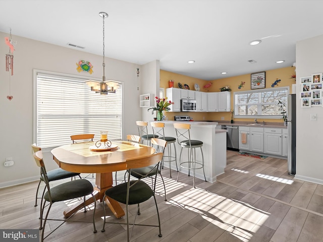 dining space with recessed lighting, visible vents, baseboards, and wood tiled floor