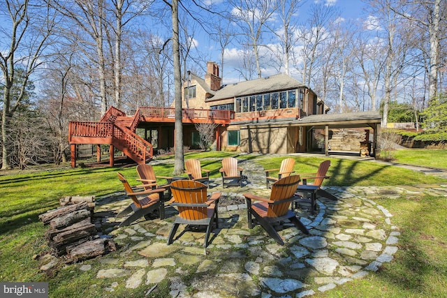 view of yard featuring a patio, a deck, stairs, and an outdoor fire pit