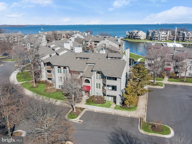 drone / aerial view featuring a residential view and a water view