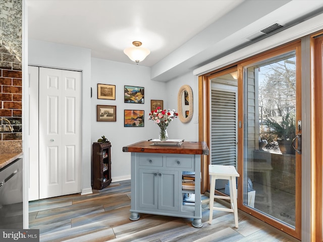 interior space with visible vents, baseboards, and light wood-style flooring