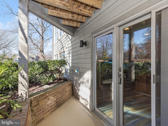 exterior space featuring wood walls and a wealth of natural light