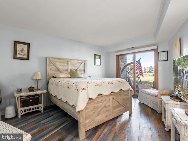 bedroom with dark wood-style flooring and access to outside