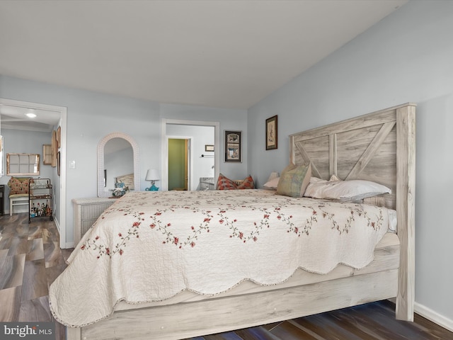 bedroom featuring dark wood-style floors and baseboards