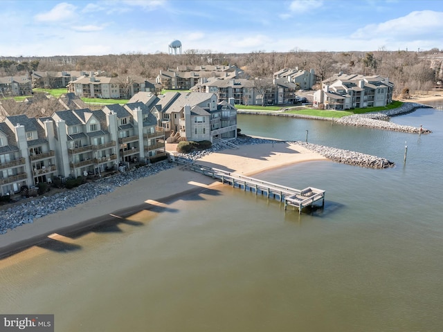 drone / aerial view featuring a residential view and a water view