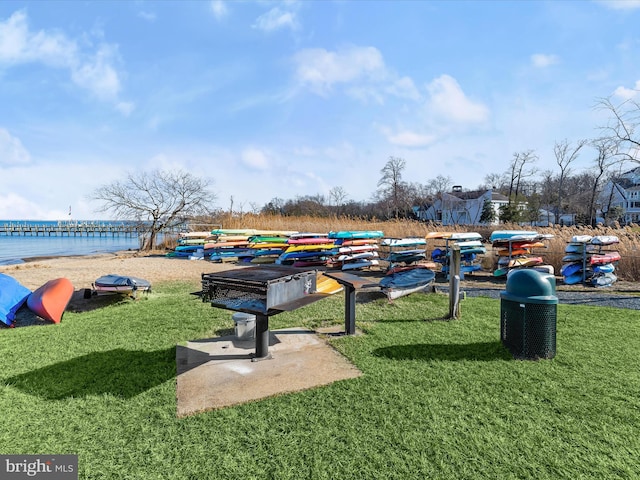 view of property's community with a yard and a water view