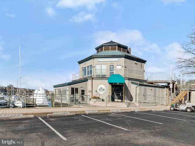 view of building exterior with uncovered parking