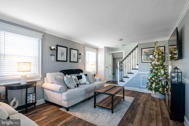 living area featuring dark wood-style floors, stairs, and crown molding