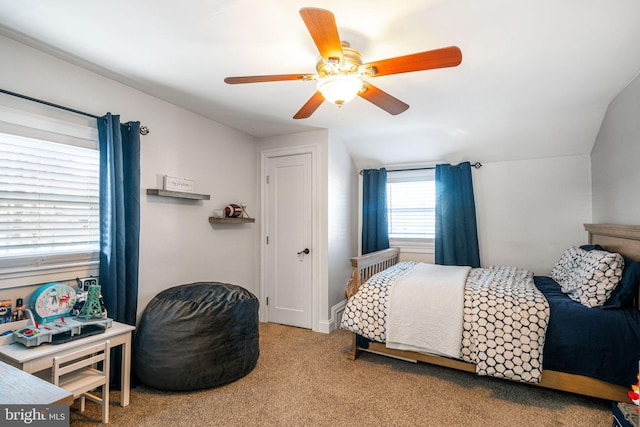 carpeted bedroom featuring lofted ceiling and a ceiling fan