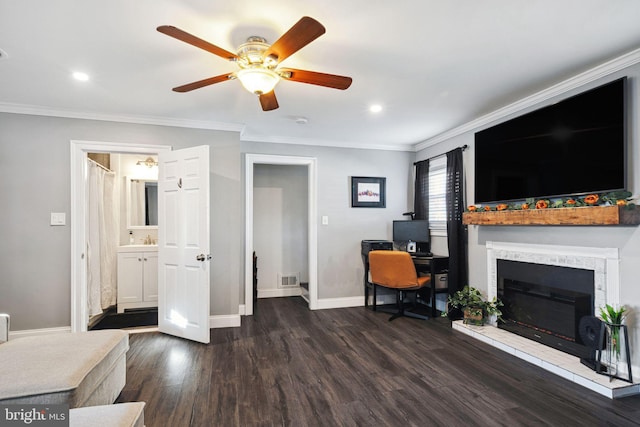 office featuring crown molding, baseboards, dark wood-style flooring, and a sink