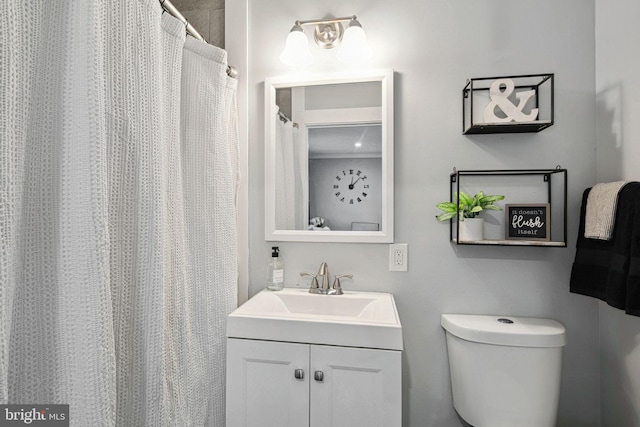 bathroom featuring toilet and vanity