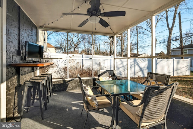 view of patio with outdoor dining area, a ceiling fan, outdoor dry bar, and fence private yard