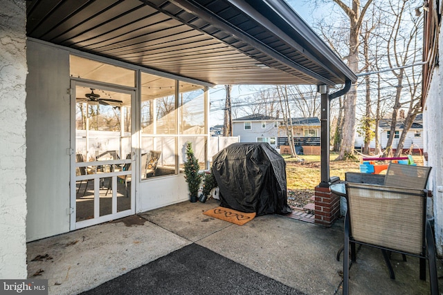 view of patio with grilling area and a sunroom