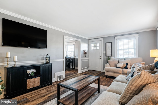 living area with plenty of natural light, dark wood-style flooring, and ornamental molding