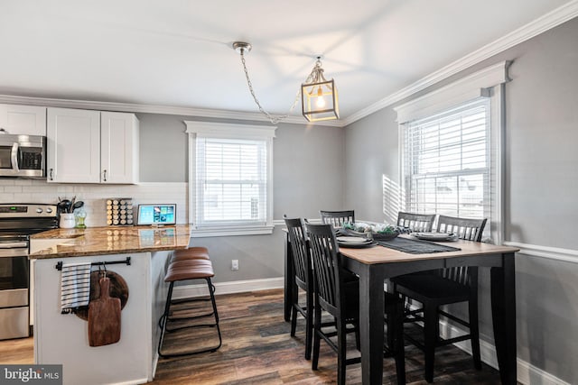 dining area featuring crown molding, baseboards, and dark wood-type flooring