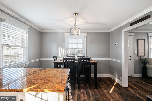 dining space featuring baseboards, dark wood-style flooring, and ornamental molding